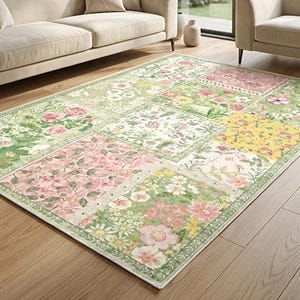 May include: A rectangular area rug featuring a patchwork design of various floral patterns in shades of green, pink, yellow, and white. The rug displays distinct square sections, each filled with different botanical illustrations of flowers and leaves.