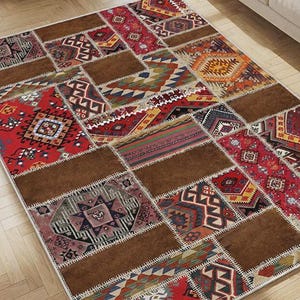 May include: A rectangular area rug featuring a patchwork design of solid brown panels interspersed with sections of intricate, multi-colored geometric patterns in shades of red, orange, blue, yellow, and white, all joined by visible white stitching.