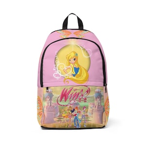 May include: A pink backpack featuring a graphic of a blonde character in a yellow circle at the top and the Winx Club logo above an illustration of five characters standing in front of a castle at the bottom, with orange wing patterns on the sides.