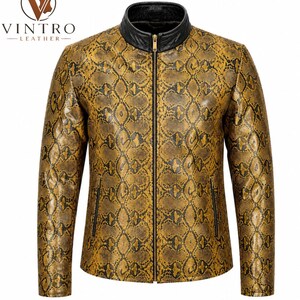 May include: A long-sleeve jacket featuring a yellow and black snakeskin pattern, a black stand-up collar, and a central gold-tone zipper. The garment includes two vertical zippered pockets on the front and displays the VINTRO LEATHER logo at the top left.