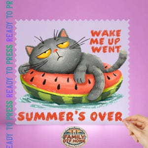 May include: A grumpy grey cat with yellow eyes rests on a watermelon float. The text "WAKE ME UP WENT" and "SUMMER'S OVER" are visible. This is a ready-to-press design.