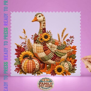 May include: A heat transfer print featuring a patchwork-style goose surrounded by autumn elements including sunflowers, pumpkins, wheat stalks, and fall leaves in shades of orange, red, green, and yellow. The text READY TO PRESS is visible.