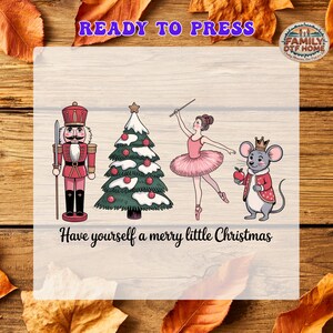 May include: A graphic print featuring a nutcracker, a snow-covered Christmas tree, a ballerina, and a mouse wearing a crown. The text reads READY TO PRESS at the top and Have yourself a merry little Christmas at the bottom.