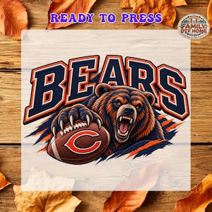 May include: A graphic transfer featuring a snarling brown bear holding a brown football with a white C logo. The word BEARS is printed in large navy blue letters with orange outlines above the bear. The text READY TO PRESS appears at the top.