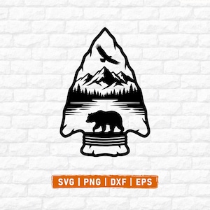 May include: A black graphic design in the shape of an arrowhead featuring a silhouette of a bear, a lake, a forest, mountains, and a flying eagle. Below the design is an orange rectangular label with the white text SVG | PNG | DXF | EPS.