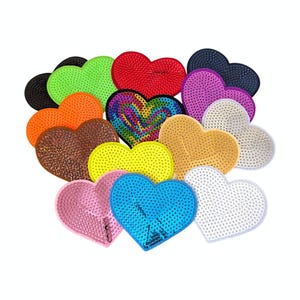 May include: A collection of heart-shaped patches in various colours and textures, including solid red, bright green, neon yellow, blue, pink, white, black, orange, brown, purple, and a multi-coloured rainbow swirl pattern, all featuring a sequined surface.