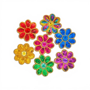 May include: A collection of six flower-shaped patches featuring sequined petals in red, yellow, blue, pink, green, and purple. Each patch has a central faceted gem surrounded by gold-toned embroidered edges, creating a vibrant and textured appearance.