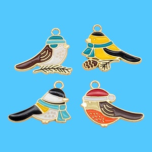 May include: Four gold-tone metal charms featuring different bird designs. Each charm has a loop at the top for attaching to a necklace, bracelet, or other jewelry. The birds are painted in various colors, including blue, red, yellow, and white.