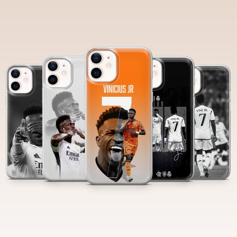 May include: Five smartphone cases featuring Vinicius Jr. in various poses and kits. The center case is orange with the text VINICIUS JR and the number 7. The other four cases are black and white, displaying the athlete in action and celebration.