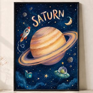 May include: A framed wall art print featuring a large, striped planet Saturn in the centre against a dark blue starry space background. The illustration includes a rocket ship, a crescent moon, floating asteroids, a book, and a green alien in a UFO.