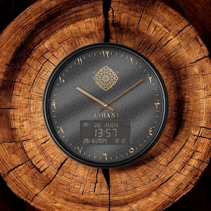 May include: A round wall clock with a black face, gold-colored hands, and Arabic-Indic numerals. The center features a gold geometric pattern, the text ADHANI, and a digital display showing 13:57, 26 JUIN, and the date 26/6/2025 in a dark frame.