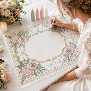 K&ouml;nnte beinhalten: Ein rechteckiges Acrylschild mit einem Rand im Buntglas-Stil, verziert mit rosa Rosen und gr&uuml;nen Bl&auml;ttern, das einen leeren Bereich in der Mitte umschlie&szlig;t. Das Design zeigt goldfarbene Konturen auf einer klaren, glatten Oberfl&auml;che.
