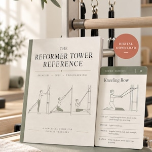 May include: A beige instructional manual titled The Reformer Tower Reference with a matching exercise card labelled Kneeling Row. The manual features black line drawings of a person using a Pilates tower, with text detailing exercises, cues, and programming.
