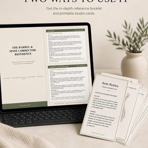 May include: A digital tablet displaying a reference guide for a barrel and spine corrector, accompanied by a stack of printed studio cards titled Arm Series. The text includes instructions for chest and shoulder opening and leg series exercises.