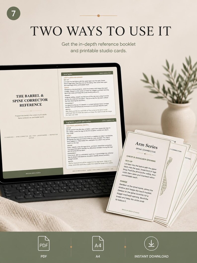 May include: A digital tablet displaying a reference guide for a barrel and spine corrector, accompanied by a stack of printed studio cards titled Arm Series. The text includes instructions for chest and shoulder opening and leg series exercises.