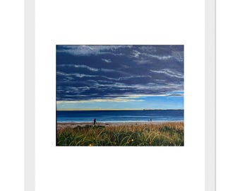 May include: A framed landscape painting depicting a coastal scene with tall golden beach grass in the foreground, a sandy shoreline, and a calm blue ocean under a dramatic, dark, cloud-filled sky with a thin horizontal band of light.
