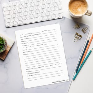 May include: A white sheet of paper with lines and prompts for a therapy session, with the text "Philoxenia Counseling, PLLC" at the bottom. A keyboard, a cup of coffee, pencils, and binder clips are also visible.