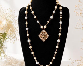 Collar largo vintage de Chanel con perlas y cristales, con colgante de medallón CC en tono dorado.