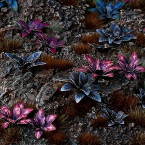 May include: A detailed close-up of a miniature landscape featuring various colorful plants. The scene includes blue, purple, and pink flowers, along with brown and green grass, set against a textured, rocky background. The overall aesthetic is naturalistic.