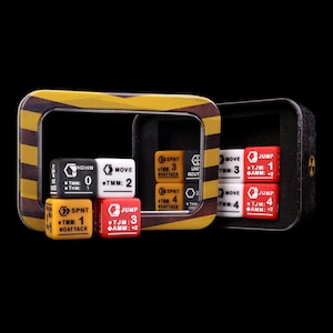 May include: A set of square game dice in black, white, yellow, and red, featuring printed text and numerical values such as MOVE, JUMP, SPNT, and HDWN. The dice are displayed inside and in front of a rectangular metal tin with yellow and black stripes.