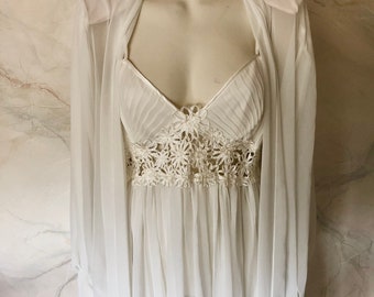 May include: White sheer nightgown with a lace trim and matching robe. The nightgown has a sweetheart neckline and the robe has long sleeves.