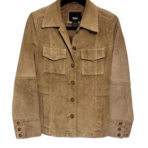 May include: A tan suede jacket with a collared neckline, two chest pockets, and two lower pockets. The jacket has a button-up front and buttoned cuffs. The brand name "Mossimo" is visible on a tag near the collar.
