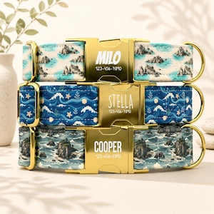May include: Three pet collars with gold-tone metal buckles. The top collar features a coastal island print with the name MILO and 123-456-7890. The middle collar has a blue ocean wave pattern with the name STELLA and 123-456-7890. The bottom collar shows a rocky sea scene with the name COOPER and 123-456-7890.