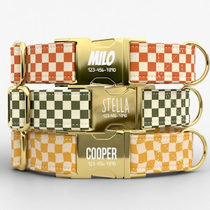 May include: Three dog collars with gold-colored buckles and D-rings. Each collar features a different checkered pattern in orange and cream, green and cream, and yellow and cream. The buckles are engraved with names and phone numbers.
