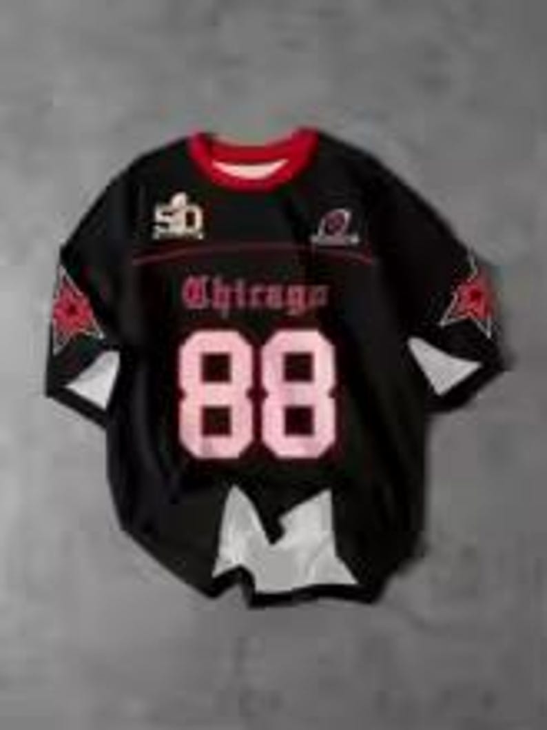 May include: Black football jersey with the word "Chicago" in pink gothic lettering and the number "88" in pink. The jersey has red and white accents, with star designs on the sleeves. The Super Bowl logo is visible.