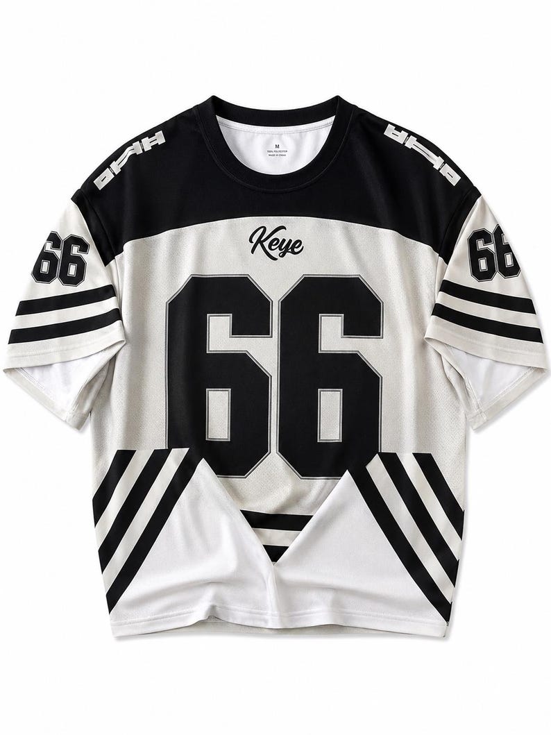 May include: A black and white jersey-style t-shirt with the number "66" on the front and sleeves. The word "Keye" is printed above the number. The shirt has black stripes on the sleeves and a black panel across the shoulders.