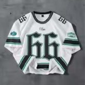 May include: White mesh jersey with the number "66" in a bold, dark green font across the front. The jersey has black and green stripes on the sleeves and a black collar. The number "66" is also on the shoulders.