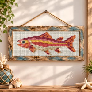 May include: A rectangular cross-stitch artwork featuring a fish with scales in shades of red, orange, yellow, and cream. The piece is encased in a weathered, distressed wooden frame with blue and brown tones, suspended by a thick jute rope.