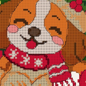 May include: A cross-stitch pattern featuring a brown and white dog with closed eyes and pink cheeks, wearing a red scarf with white snowflake-like patterns. The design includes dark brown ears, a black nose, and a red mouth against a grid background.