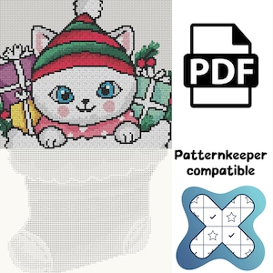 May include: A cross-stitch pattern featuring a white cat wearing a red and green striped hat with a white pom-pom, surrounded by gifts and holly. The design includes a PDF icon, the text Patternkeeper compatible, and a blue logo.