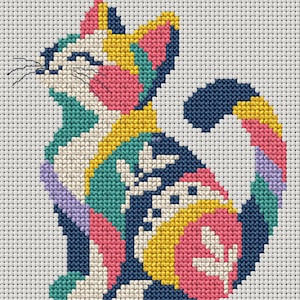 May include: A cross-stitch pattern of a sitting cat featuring a vibrant color palette of navy blue, bright yellow, pink, teal, and lavender. The cat is depicted in profile with stitched whiskers and stylized leaf motifs on its body and tail.