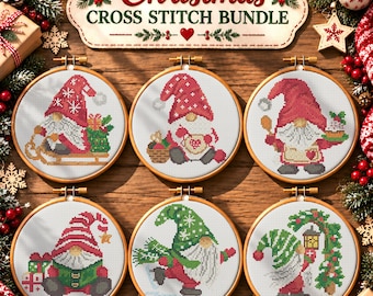 May include: A Christmas cross stitch bundle featuring six circular wooden embroidery hoops, each displaying a unique gnome design in red, green, and white thread. The top sign reads Christmas CROSS STITCH BUNDLE in red and green text.