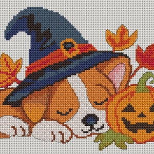 May include: A cross-stitch pattern featuring a sleeping puppy wearing a dark blue witch hat with an orange band. The puppy is positioned next to a carved orange jack-o'-lantern pumpkin and several scattered autumn leaves in shades of yellow and red.