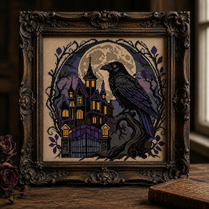 May include: A square cross-stitch embroidery featuring a black raven perched on a branch before a large moon, a dark mansion with glowing yellow windows, and a gated entrance, all enclosed within an ornate, dark brown, carved wooden frame.