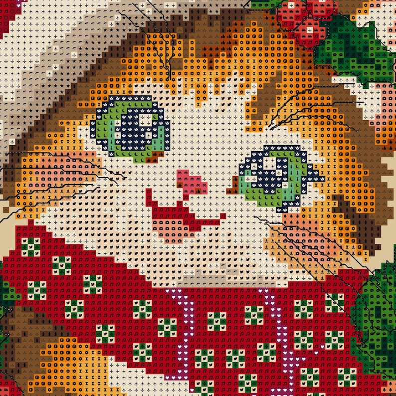 May include: A cross-stitch pattern featuring a close-up of a cat face with orange fur, green eyes, and a pink nose. The cat wears a red scarf with a green and white geometric pattern, and there are green holly leaves visible at the top right.