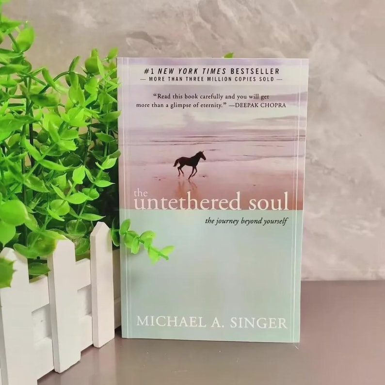 May include: A hardcover book titled "the untethered soul" by Michael A. Singer. The cover features a silhouette of a horse on a beach. Text includes "#1 New York Times Bestseller" and a quote by Deepak Chopra.