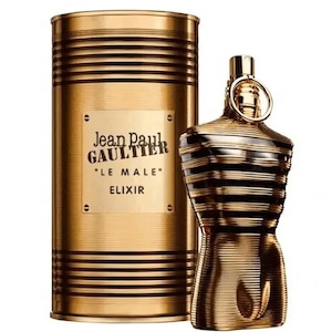 May include: A gold-toned perfume bottle and matching cylindrical container. The bottle is shaped like a torso with black stripes. The container has horizontal stripes and a label that reads "Jean Paul Gaultier LE MALE ELIXIR."