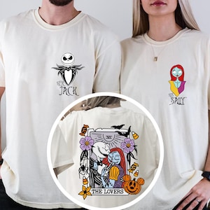 May include: Off-white t-shirts featuring small chest graphics of Jack Skellington with the text Her Jack and Sally with the text His Sally. A circular inset shows a back graphic of a tarot card titled The Lovers with Jack and Sally.