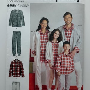 May include: A Simplicity R11670 sewing pattern envelope featuring illustrations and photographs of clothing including a button-down cardigan, plaid button-up shirt, joggers, and shorts. The text includes Simplicity, R11670, and easy-to-sew.