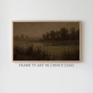 May include: A framed landscape painting depicting a tranquil marsh scene. The artwork features a muted color palette of browns and greens, with tall reeds in the foreground and a reflective body of water. The text "FRAME TV ART 4K (3840 X 2160)" is at the bottom.