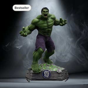 May include: A green Hulk statue with purple shorts, standing on a detailed base. The statue has an open mouth and outstretched arms, with the word "Bestseller" in a white oval in the upper left corner. The base has a glowing green effect.