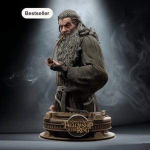 May include: A detailed bust of Gandalf from The Lord of the Rings, featuring a long gray beard and robe, holding a pipe. The base is inscribed with "The Fellowship of the Ring". The image has a "Bestseller" label.