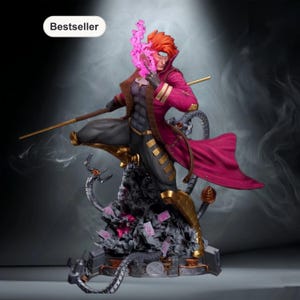 May include: A detailed statue of a comic book character with red hair, wearing a long magenta coat with gold accents. The figure is posed dynamically, holding a staff and surrounded by a smoky base with playing cards. The word "Bestseller" is in a white oval.