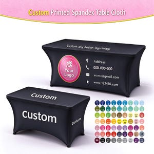 May include: Two black spandex table covers with custom printing. One features a circular logo, address, phone, email, and website text. The other displays the word Custom. A color chart with 63 numbered circles is included for selection.