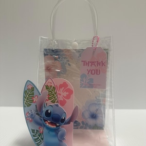 May include: A clear plastic gift bag with a handle, containing a pink tag that says "THANK YOU". A blue cartoon character with a surfboard stands in front of a pink and floral background.