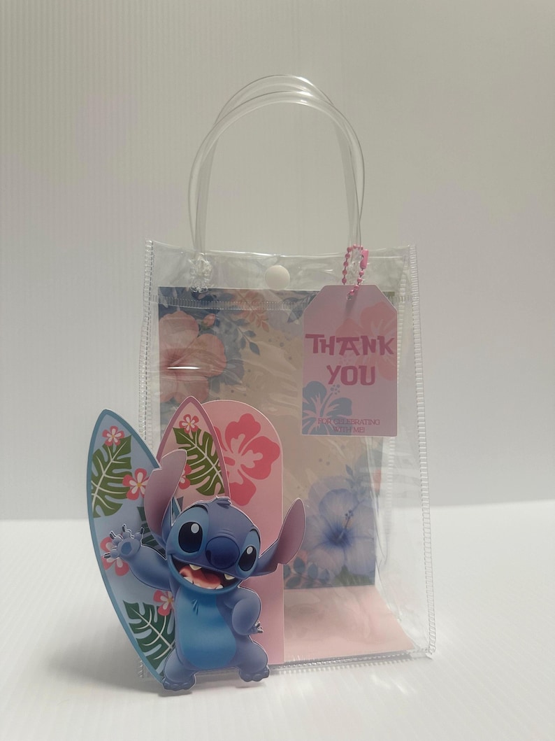 May include: Clear plastic gift bag with a blue cartoon character holding a surfboard. The bag has a pink tag that says "THANK YOU". The background has a floral design with pink and blue flowers.